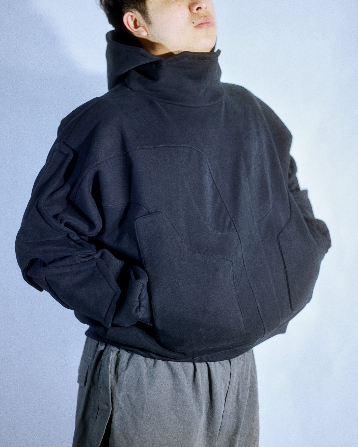 black dark dystopian heavyweight pullover hoodie, front model view