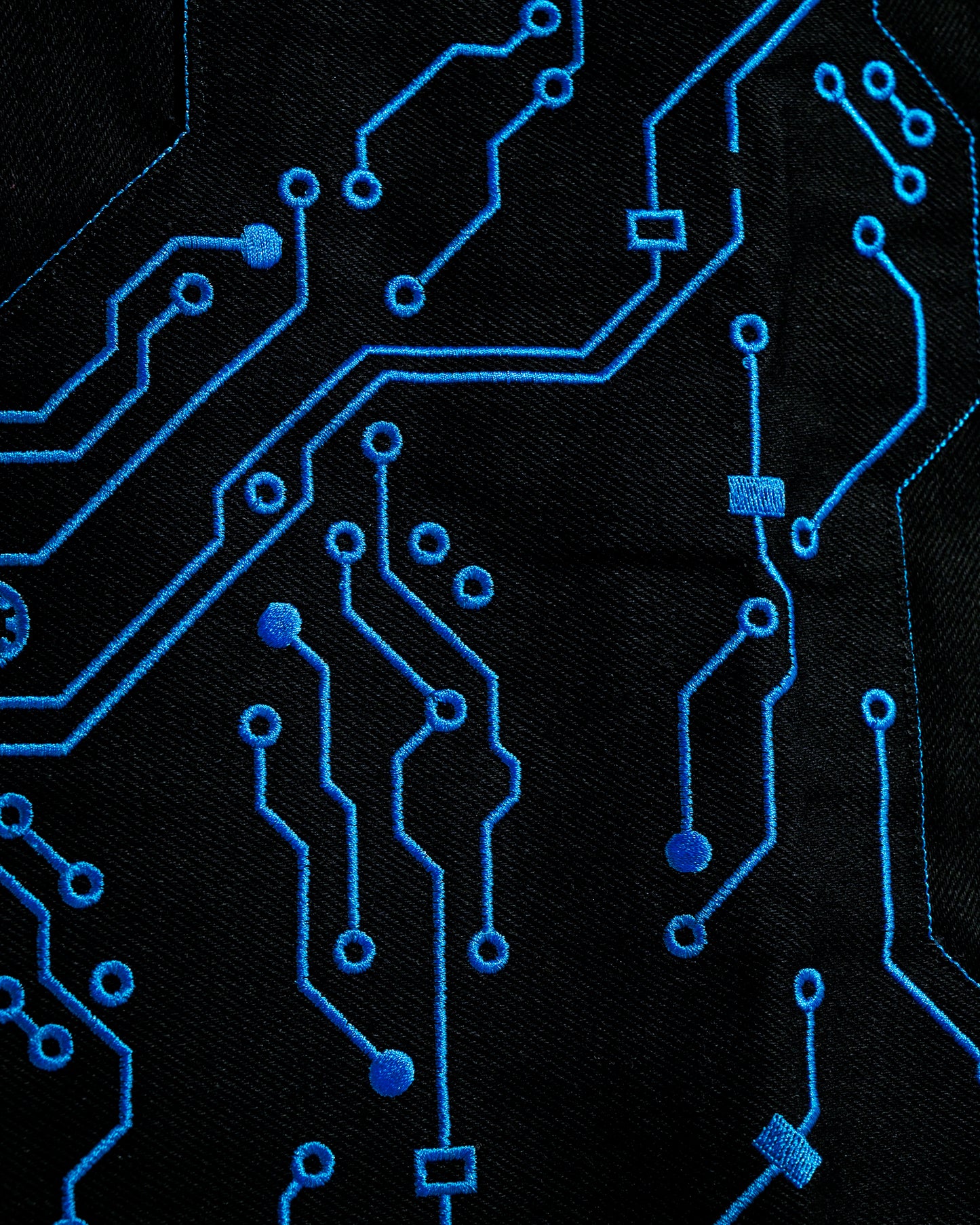 black denim grid futuristic techno circuit cyborg pants, embroidery detail view close up