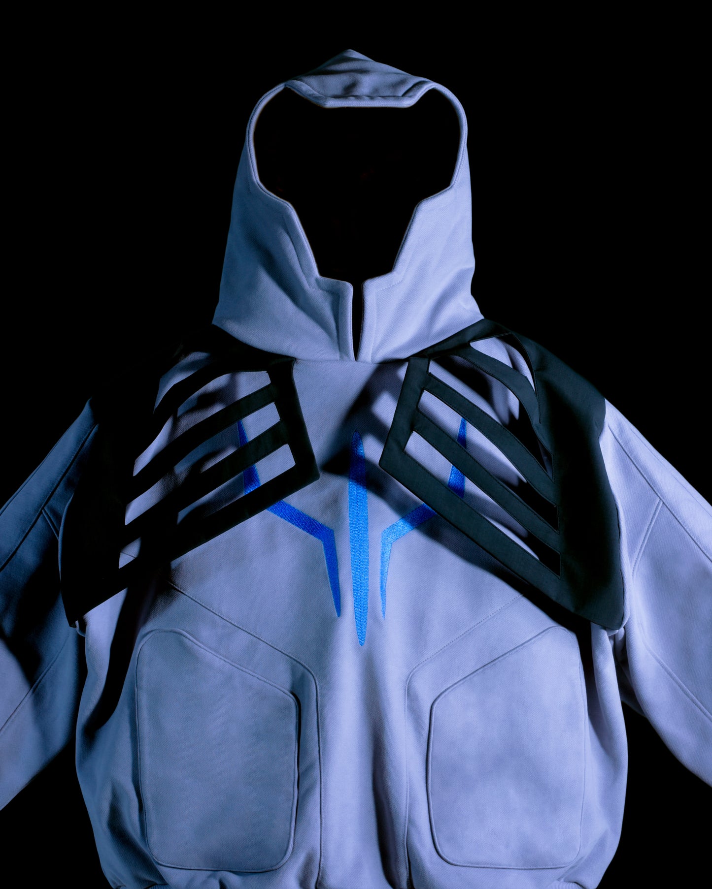 Grey hoodie with tech wear details, close up view