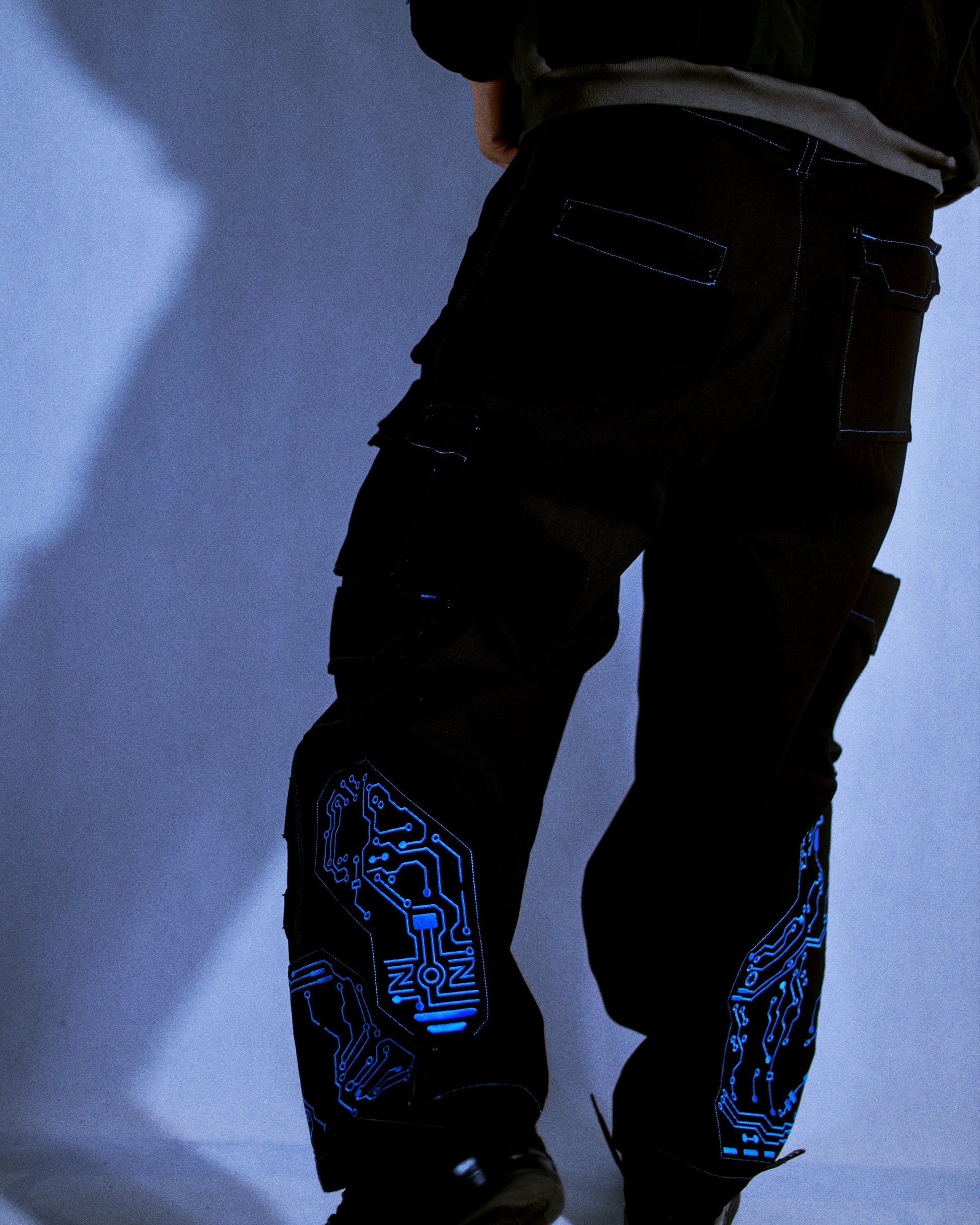 black denim grid futuristic techno circuit cyborg pants, model on body view