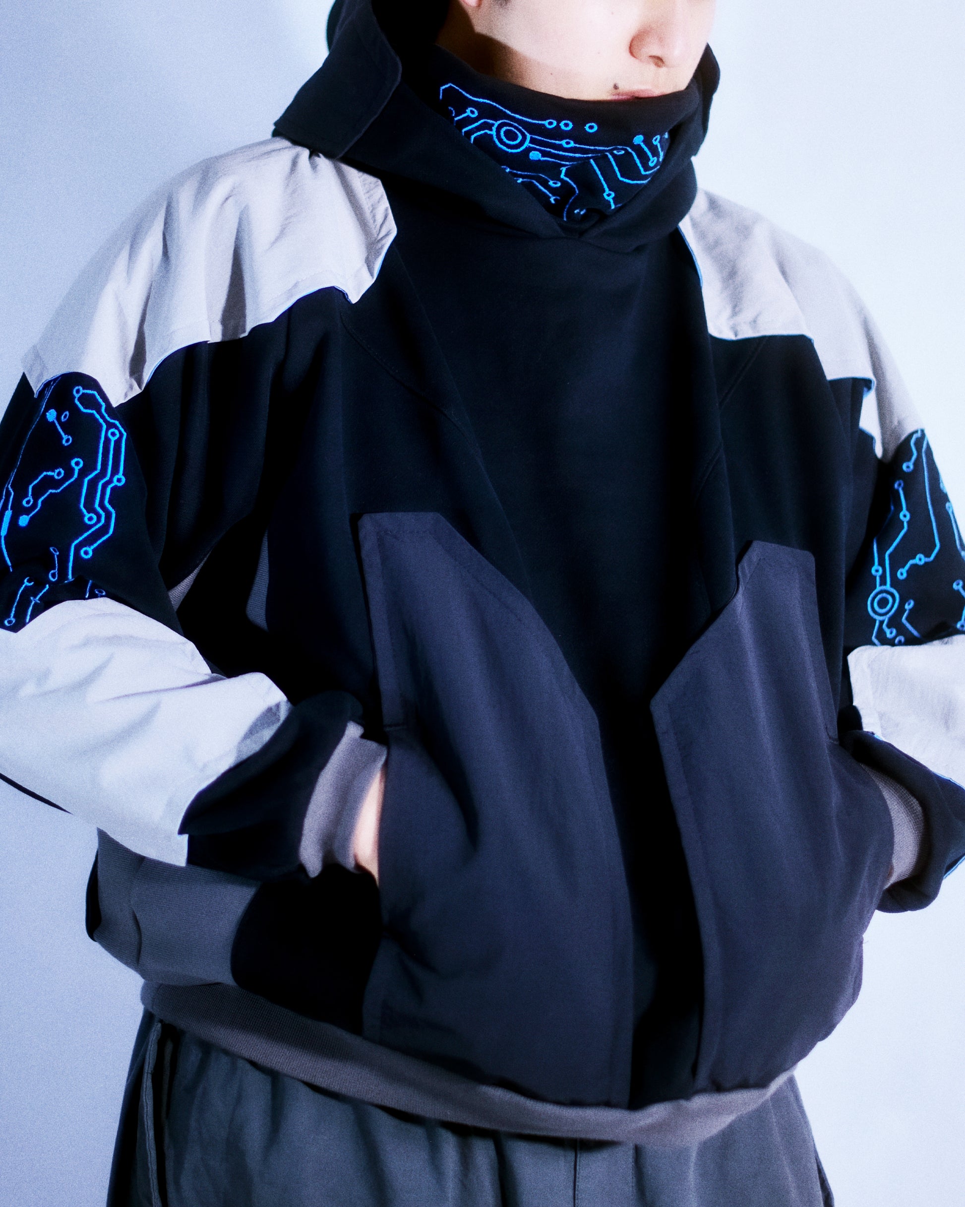 Black hoodie with futuristic grid tech wear style, front model view