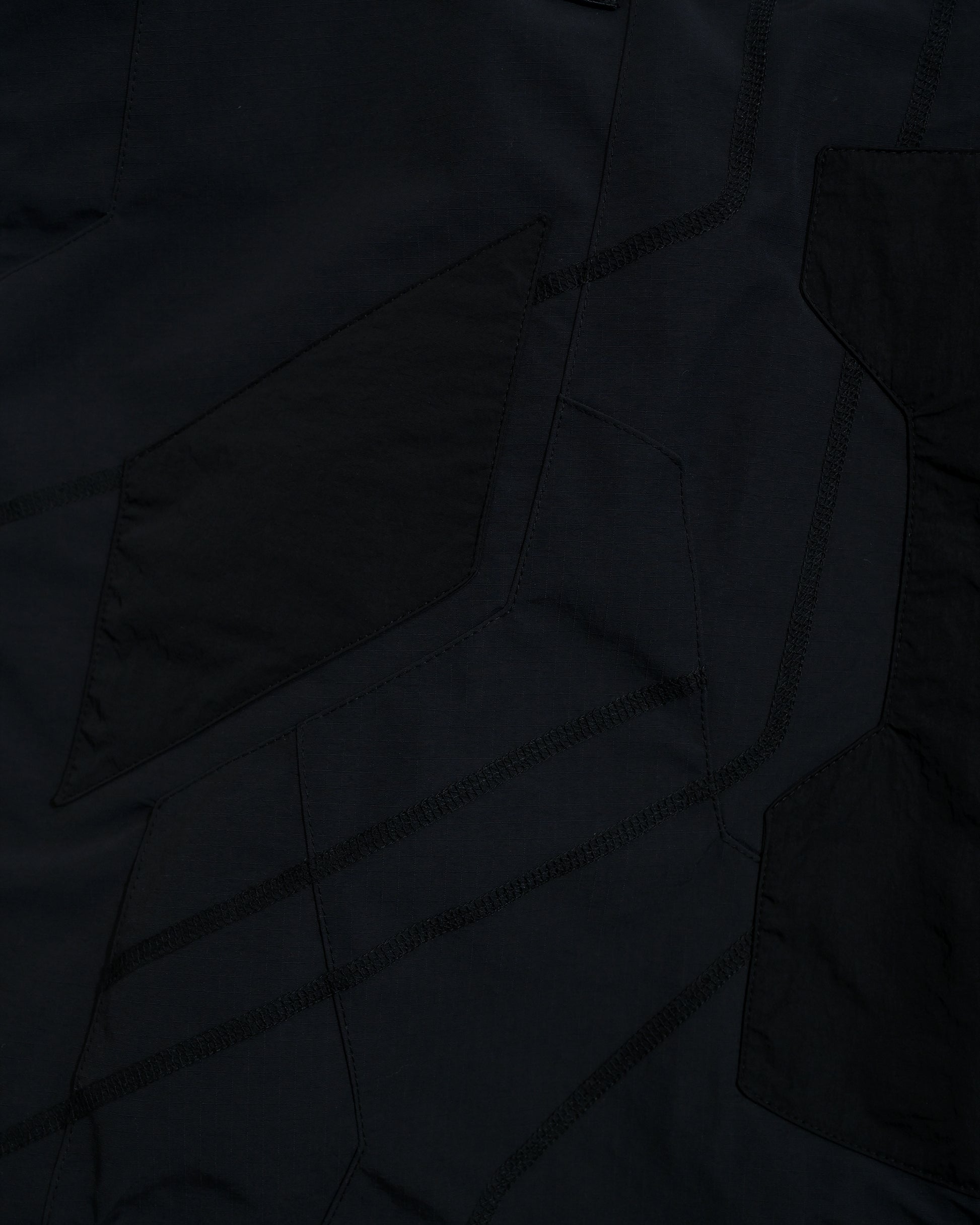 black tactical military dystopian vest, stitching detail view