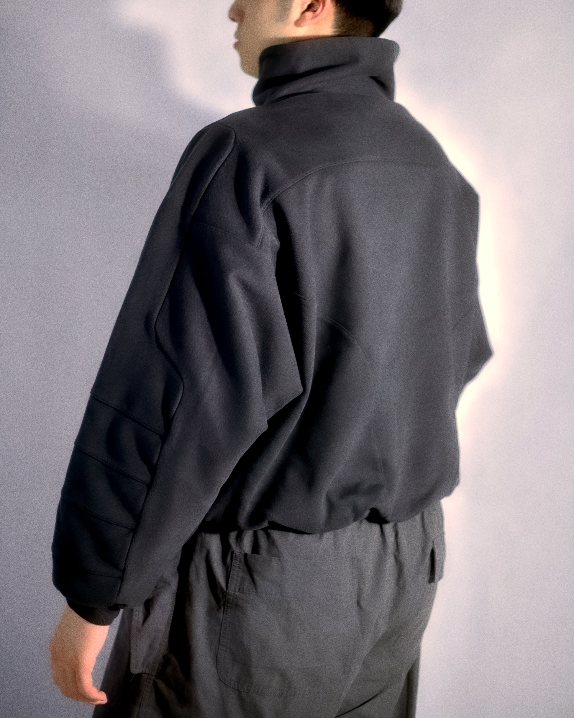 dark grey cyberspace metaverse alien sweater, back model view